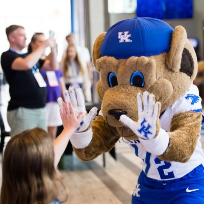 Kentucky University mascot high-fiving child at event SLC 2026.