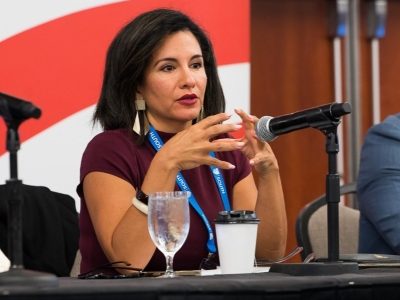 SLC 2026 female panelist speaking during conference discussion.