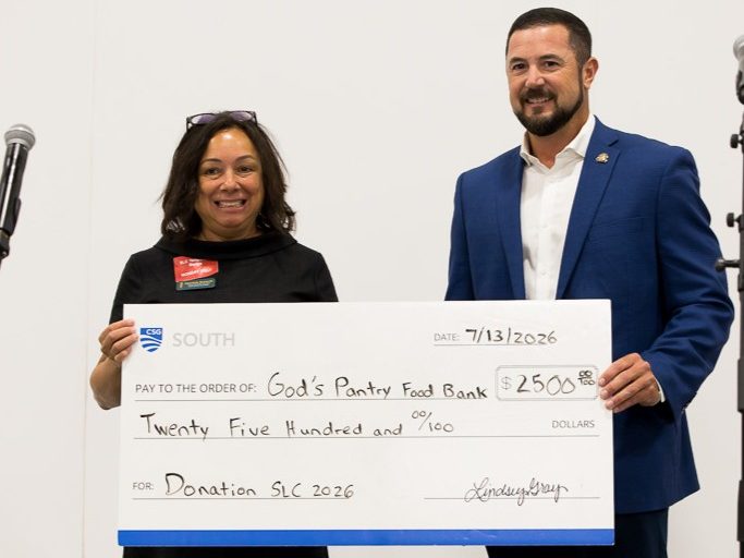 Donation check presentation at SLC conference 2026.