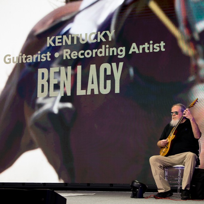 Musician Ben Lacy performing on SLC 2026 conference stage.