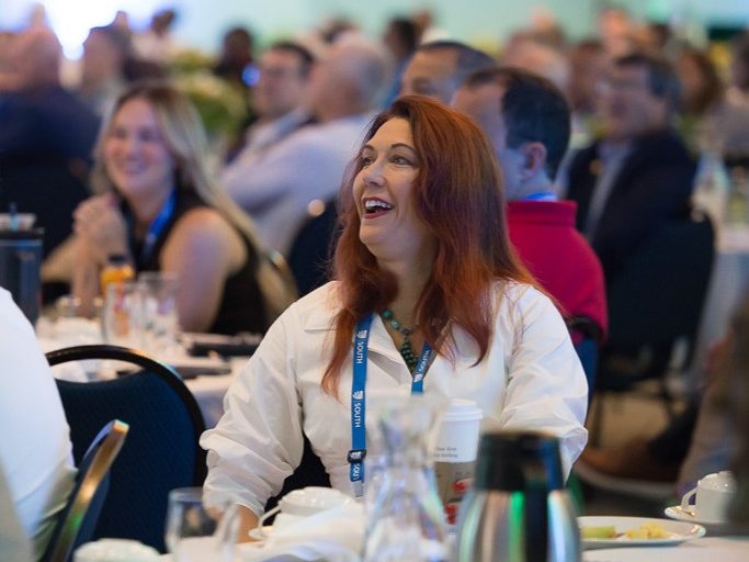 Attendee listening during SLC 2026 conference luncheon.