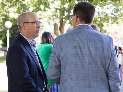 Attendees networking outdoors during SLC 2026 conference.
