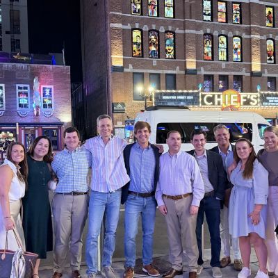 Group shot of the Chiefs 15 X 2026 class outside city night shot.