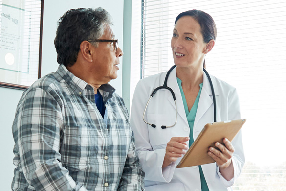 Healthcare professional consulting with a patient in a clinical setting, illustrating healthcare access, medical services, and patient care.