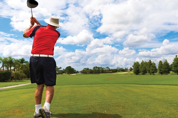 Retirement-Person golfing on a sunny golf course.