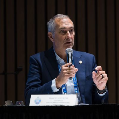Man at podium speaking at SLC 2026 policy session.