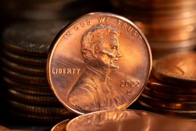 U.S. penny showing Abraham Lincoln’s profile with the words IN GOD WE TRUST