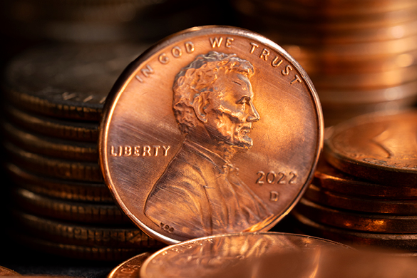 U.S. penny showing Abraham Lincoln’s profile with the words IN GOD WE TRUST
